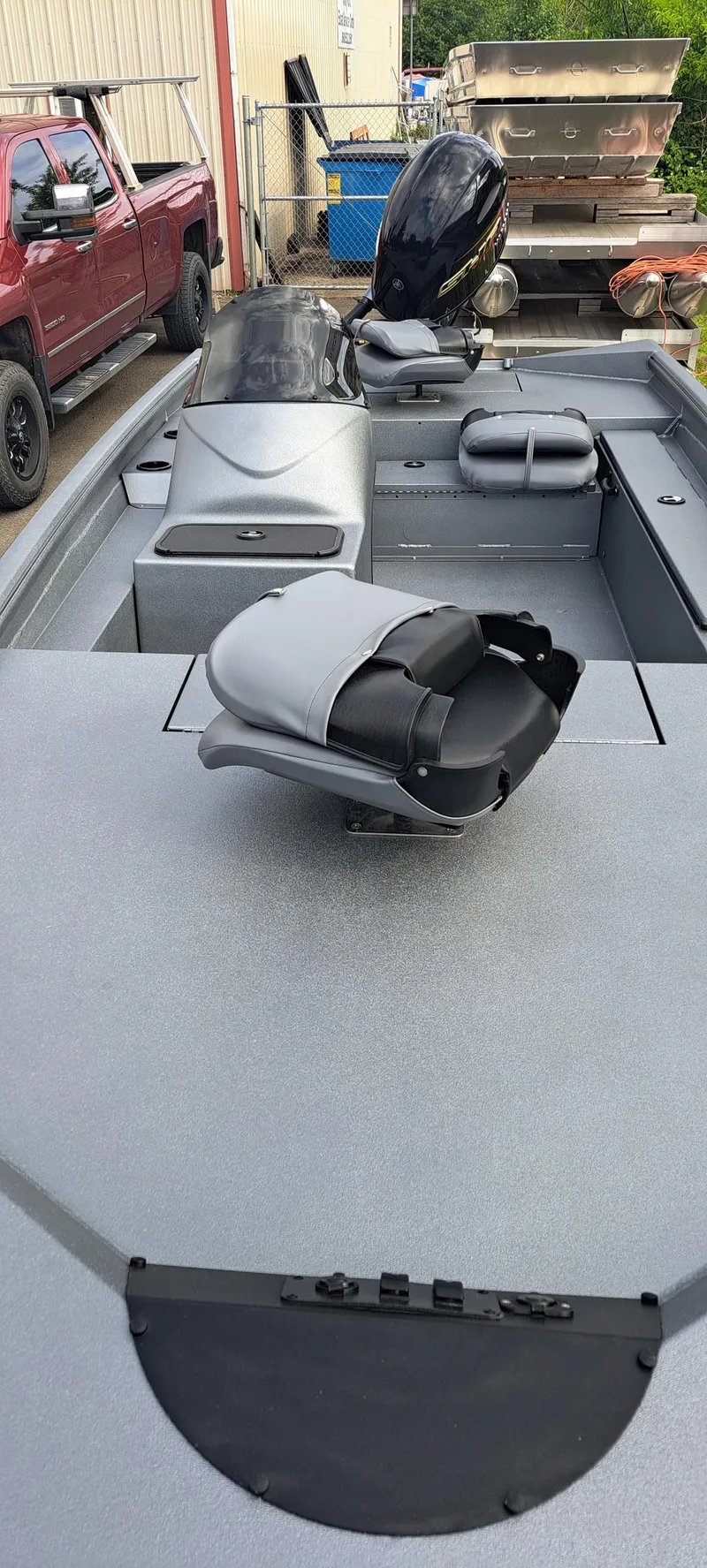 Slide: The Image of 2025 Excel 1860 Stalker SC boat with motor, parked near a red truck. - 3