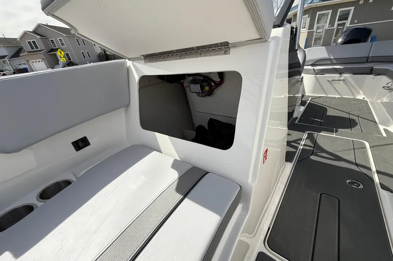 Slide: The Image of 2025 Bayliner V20 boat interior with open storage compartment and seating area. - 14