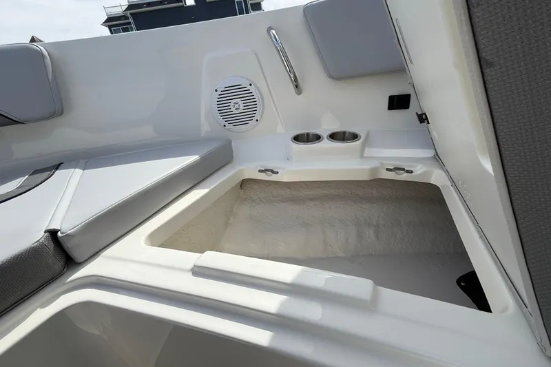 Slide: The Image of 2025 Bayliner V20 boat interior with seating, storage, and cup holders. - 16