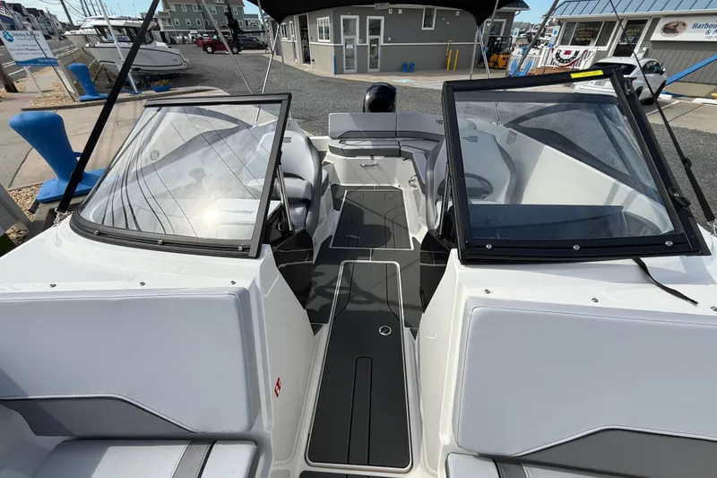 Slide: The Image of 2025 Bayliner V20 boat interior with sleek design and modern features at a marina. - 18