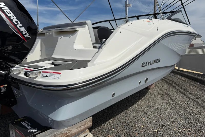 Slide: The Image of 2025 Bayliner V20 boat with Mercury engine, displayed on gravel surface. - 2
