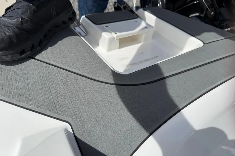 Slide: The Image of 2025 Bayliner V20 boat deck with gray non-slip surface and shoe. - 3