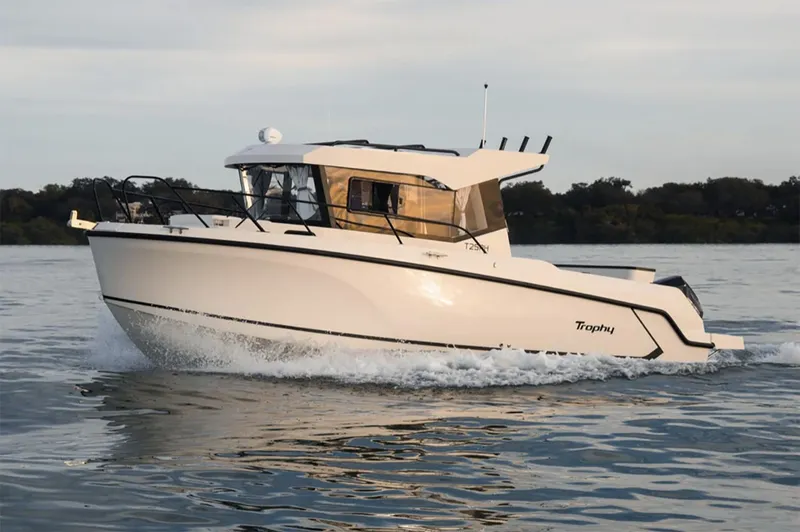 Slide: The Image of Manufacturer Provided Image: 2025 Bayliner Trophy T25 Pilothouse cruising on calm water. - 0
