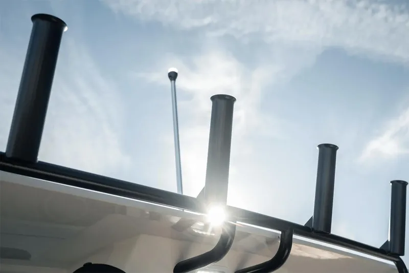 Slide: The Image of Manufacturer Provided Image: Bayliner Trophy T25 Pilothouse 2025, rod holders against a bright sky. - 7