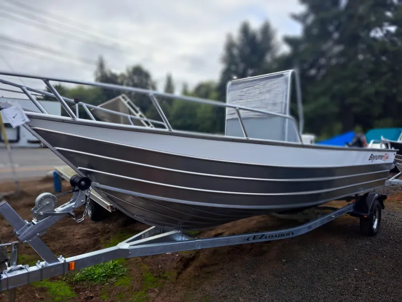 Slide: The Image of 2025 Klamath Baja Bayrunner boat on trailer, parked outdoors. - 3