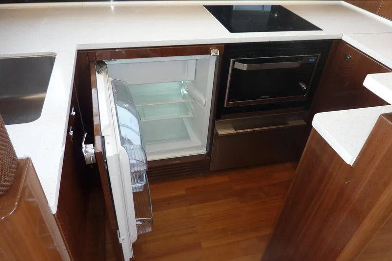 Slide: The Image of Modern kitchen in 2017 Princess 52 yacht with open fridge and sleek appliances. - 16
