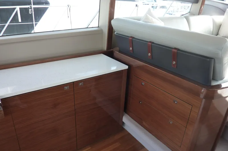 Slide: The Image of Interior of 2017 Princess 52 yacht with wooden cabinetry and cushioned seating. - 21