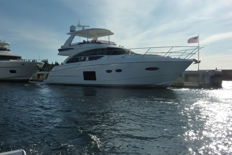Slide: The Image of 2017 Princess 52 yacht docked, American flag waving, under clear sky. - 3