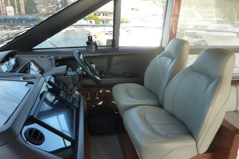 Slide: The Image of Interior helm of 2017 Princess 52 yacht with dual leather seats and modern controls. - 34