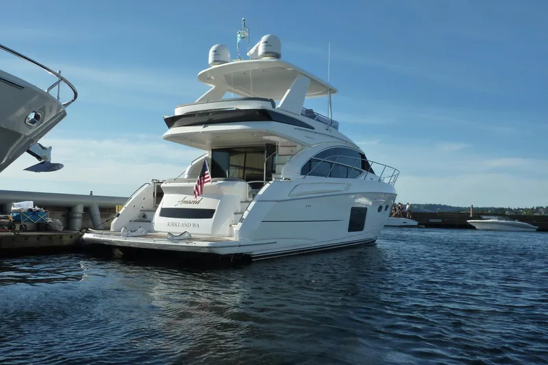 Slide: The Image of 2017 Princess 52 yacht docked in marina, rear view with American flag. - 4