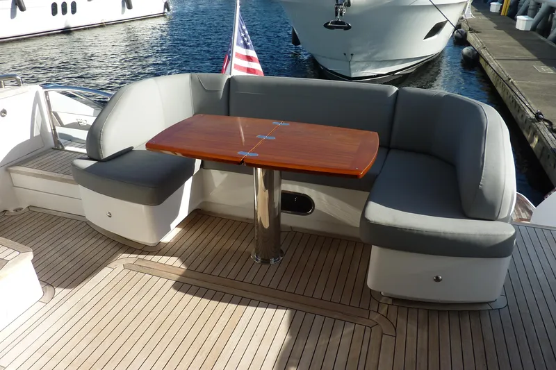 Slide: The Image of Luxurious seating area on 2017 Princess 52 yacht with wooden table and American flag. - 7
