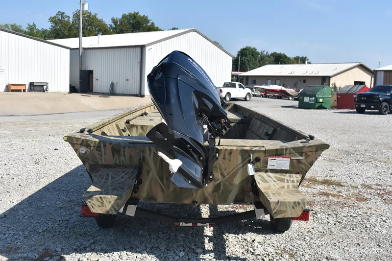 Slide: The Image of 2026 Lowe Roughneck 1860 boat with outboard motor on gravel lot. - 5