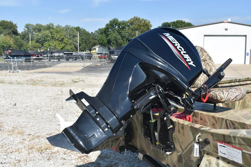 Slide: The Image of 2026 Lowe Roughneck 1860 boat with Mercury outboard motor in a sunny outdoor setting. - 6
