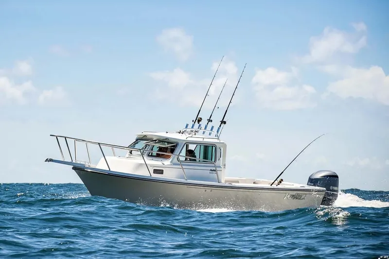 Slide: The Image of 2022 Parker 2320 SL Sport Cabin boat cruising on open water under clear skies. - 10
