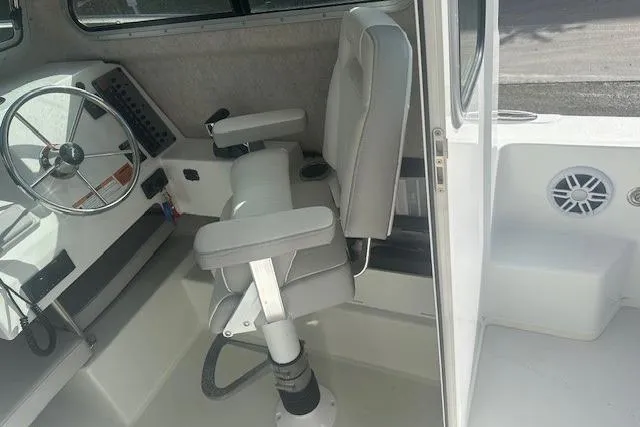 Slide: The Image of 2022 Parker 2320 SL Sport Cabin interior with steering wheel and captain's chair. - 4