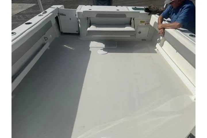 Slide: The Image of 2022 Parker 2320 SL Sport Cabin boat deck with seating and storage. - 6