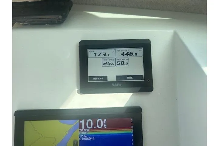 Slide: The Image of Yamaha display on 2022 Parker 2320 SL Sport Cabin showing fuel usage and trip distance. - 7