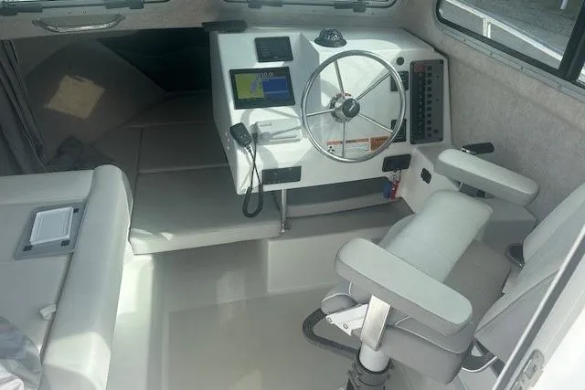 Slide: The Image of 2022 Parker 2320 SL Sport Cabin interior with steering wheel and navigation display. - 8