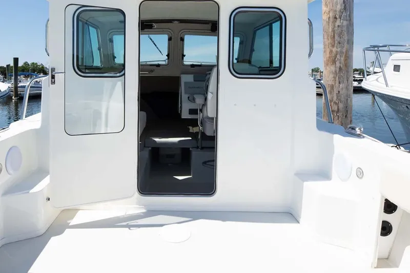 Slide: The Image of 2022 Parker 2320 SL Sport Cabin boat interior view at marina. - 9