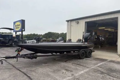 Slide: The Image of 2026 Skeeter ZXE21 boat on trailer outside a garage. - 4