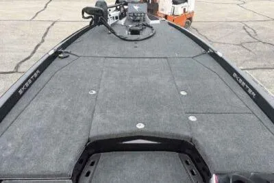 Slide: The Image of 2026 Skeeter ZXE21 boat deck with gray carpet and storage compartments. - 8