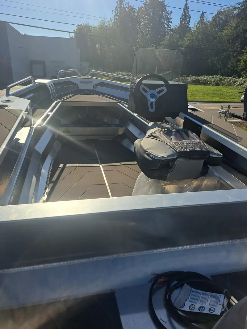 Slide: The Image of 2024 Stabicraft 1450 Frontier boat interior with steering wheel and seating. - 1