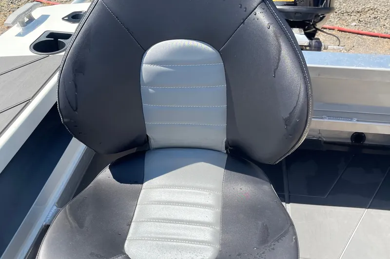 Slide: The Image of 2024 Stabicraft 1450 Frontier boat seat, black and gray, wet with water droplets. - 17