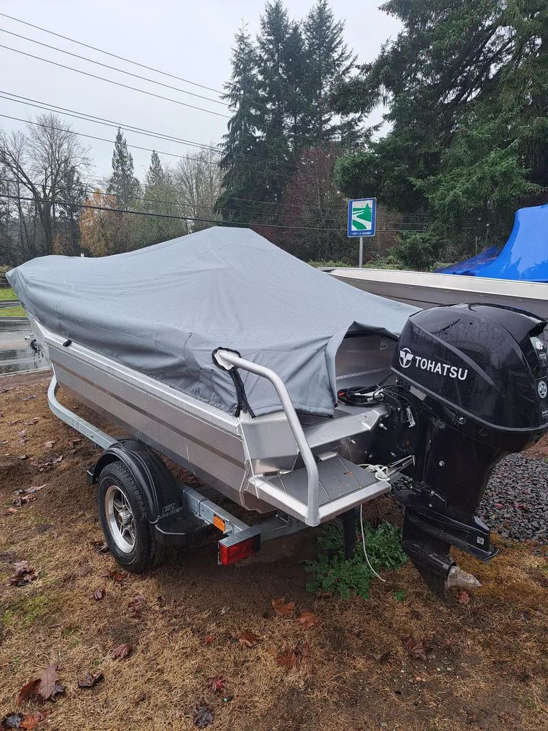 Slide: The Image of 2024 Stabicraft 1450 Frontier boat with Tohatsu engine, covered and on trailer. - 3