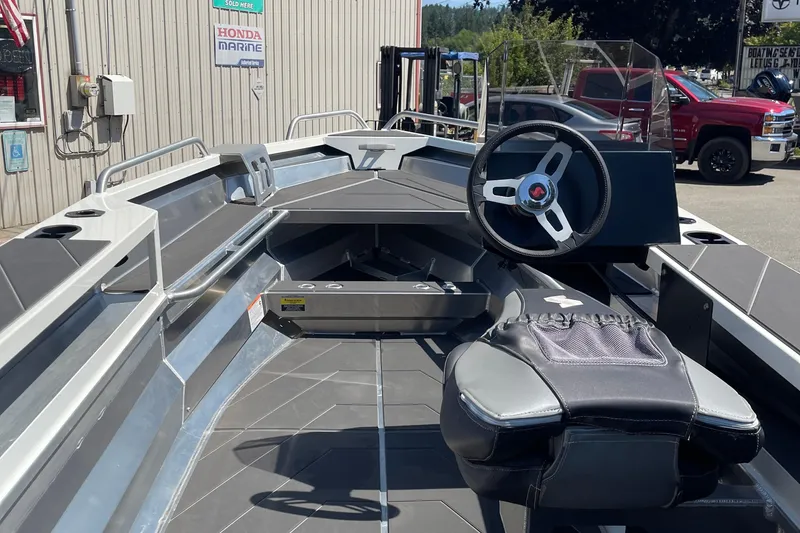 Slide: The Image of 2024 Stabicraft 1450 Frontier boat interior with steering wheel and seating. - 6
