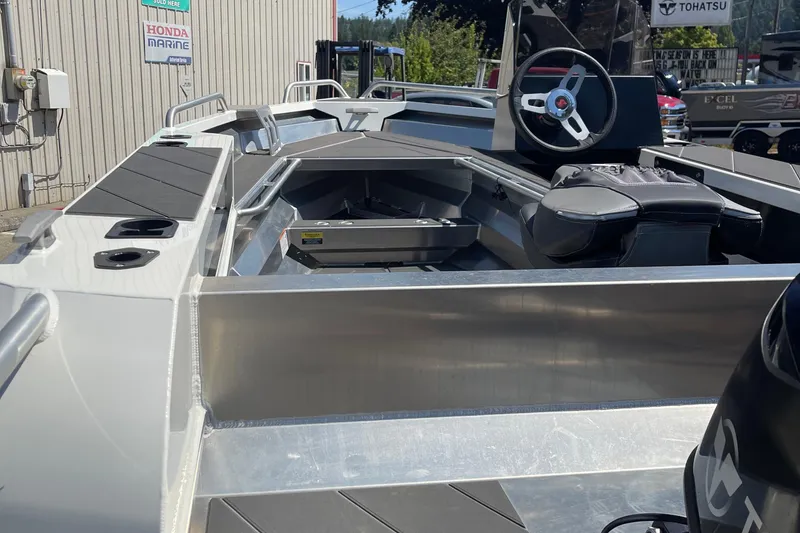 Slide: The Image of 2024 Stabicraft 1450 Frontier boat interior with steering wheel and seating. - 8