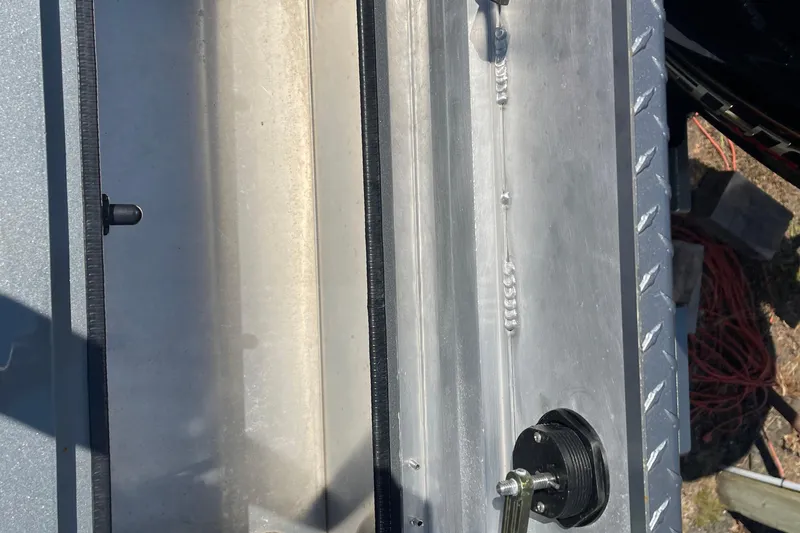 Slide: The Image of 2025 Excel Buoy 10 boat detail showing metal construction and hardware components. - 13