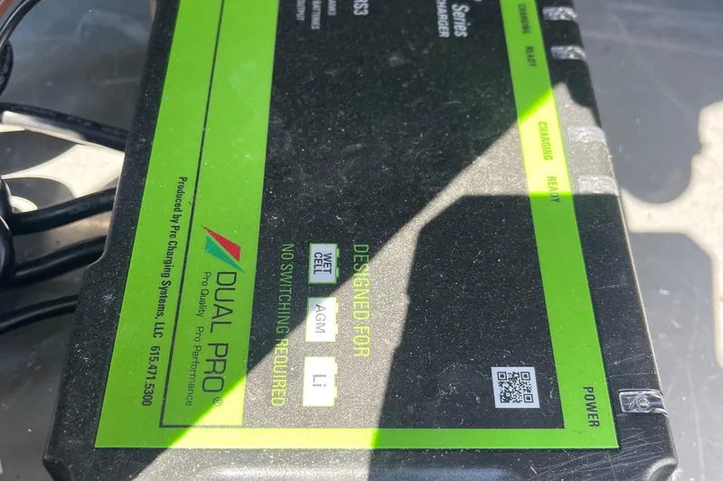 Slide: The Image of Dual Pro battery charger with green label, designed for various battery types, Excel Buoy 10, 2025. - 17