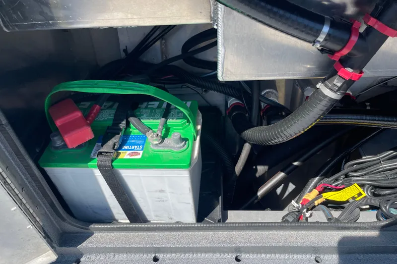 Slide: The Image of Battery compartment of 2025 Excel Buoy 10 boat with wiring and connections. - 18