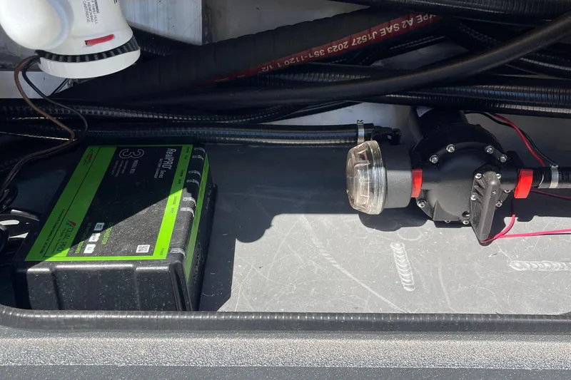 Slide: The Image of Electrical components inside Excel Buoy 10, 2025 model, featuring wiring and a battery charger. - 20