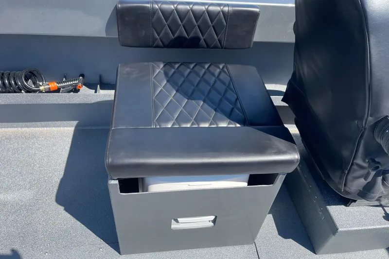 Slide: The Image of Black leather seat on Excel Buoy 10 boat, 2025 model, with storage compartment. - 23