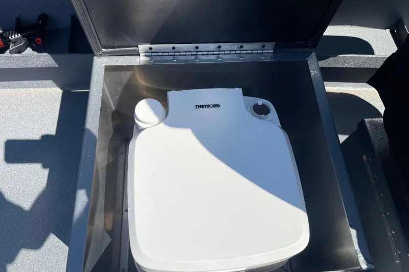 Slide: The Image of Portable toilet in Excel Buoy 10 boat, 2025 model, with open storage compartment. - 24