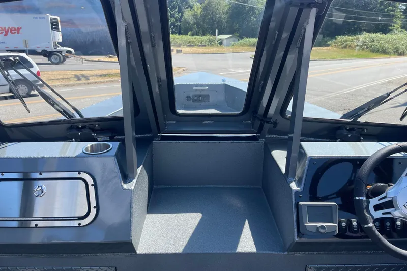 Slide: The Image of Interior view of 2025 Excel Buoy 10 boat cockpit with steering wheel and controls. - 26
