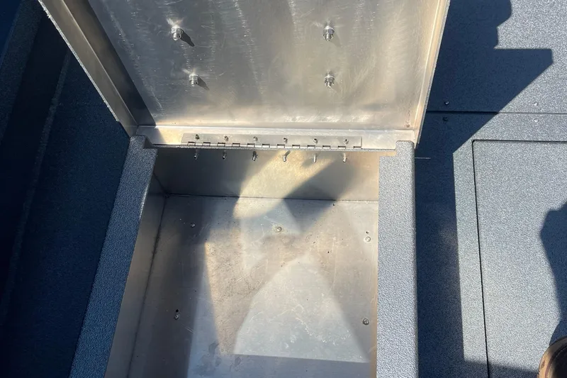 Slide: The Image of Open storage compartment in 2025 Excel Buoy 10 boat, showing interior details. - 27