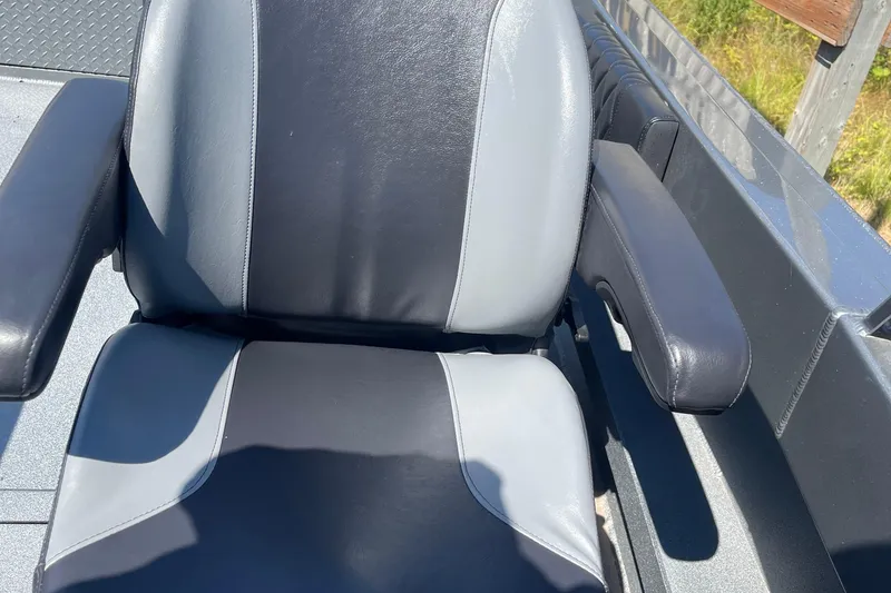 Slide: The Image of Comfortable seat in 2025 Excel Buoy 10 boat, featuring black and gray upholstery. - 29
