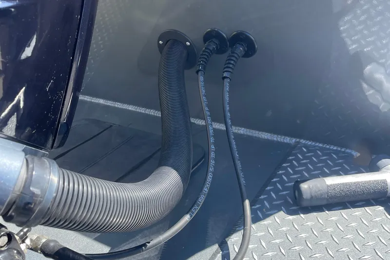 Slide: The Image of Close-up of Excel Buoy 10 boat cables and hoses, 2025 model, on diamond plate flooring. - 8