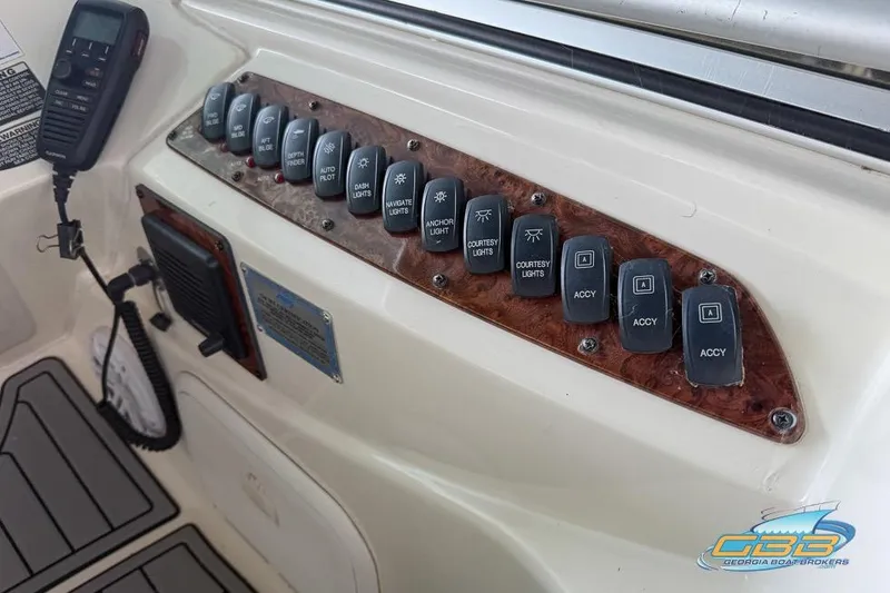 Slide: The Image of Control panel of a 2007 Meridian 341 Sedan boat with labeled switches and radio. - 21