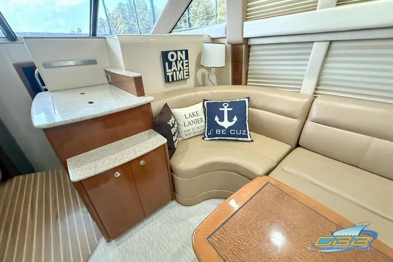Slide: The Image of 2007 Meridian 341 Sedan interior with beige seating, nautical decor, and wooden accents. - 22