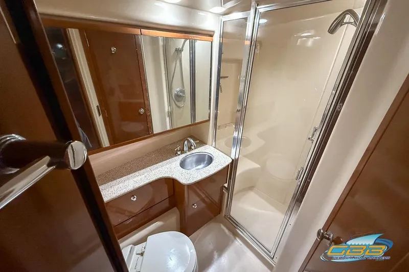 Slide: The Image of 2007 Meridian 341 Sedan bathroom with shower, sink, and wooden cabinetry. - 27