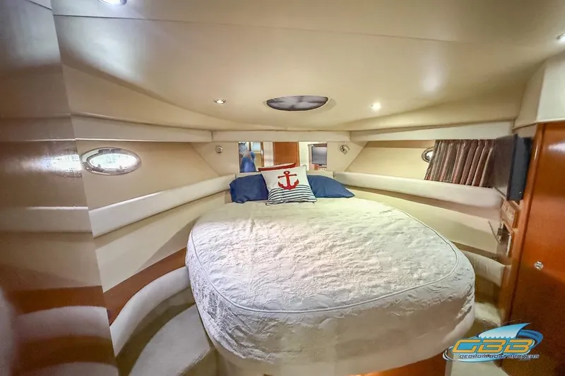 Slide: The Image of Luxurious 2007 Meridian 341 Sedan yacht bedroom with cozy bedding and nautical decor. - 28