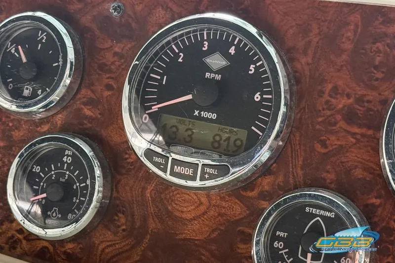Slide: The Image of Dashboard gauges of a 2007 Meridian 341 Sedan boat, featuring RPM and pressure indicators. - 34