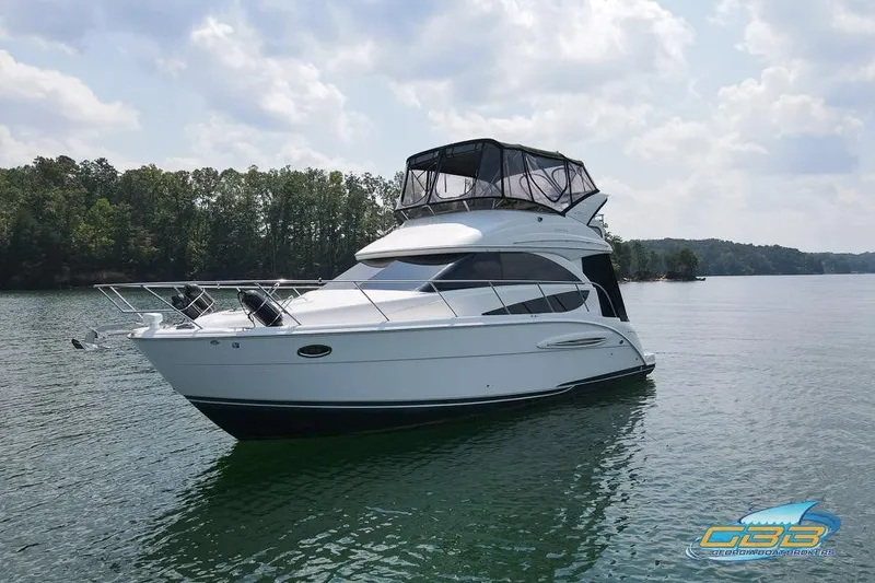 Slide: The Image of 2007 Meridian 341 Sedan yacht on a serene lake with forested shoreline. - 36