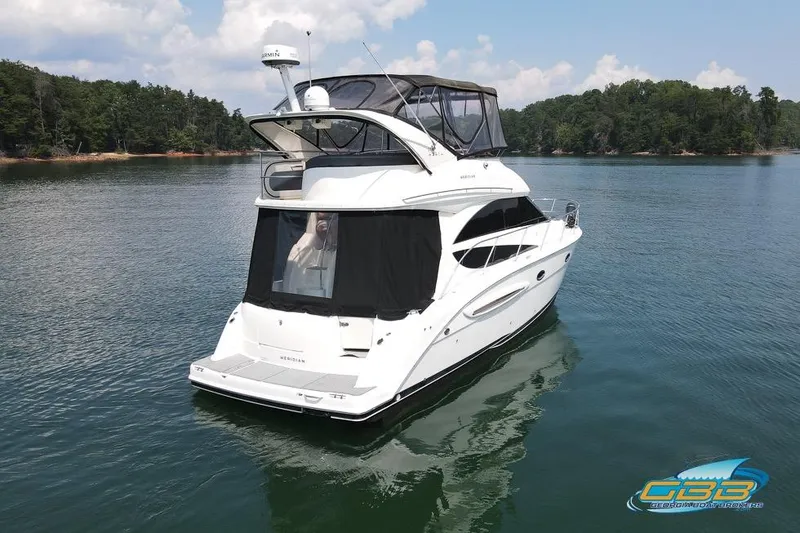 Slide: The Image of 2007 Meridian 341 Sedan yacht on calm lake with forested shoreline. - 37