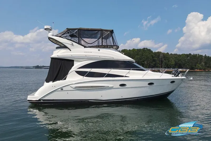 Slide: The Image of 2007 Meridian 341 Sedan yacht on calm water with forested shoreline. - 4