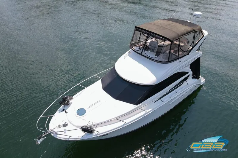 Slide: The Image of 2007 Meridian 341 Sedan yacht on calm water, featuring a sleek design and spacious upper deck. - 5