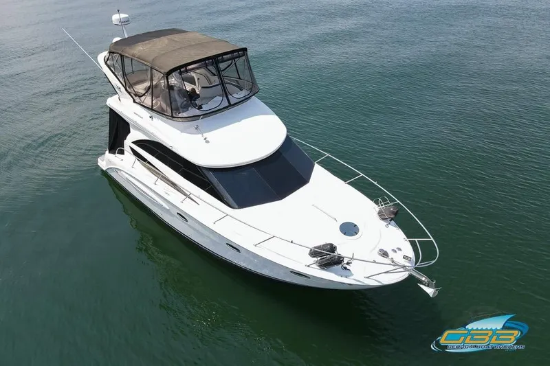 Slide: The Image of 2007 Meridian 341 Sedan yacht on calm water, featuring a sleek design and spacious upper deck. - 6